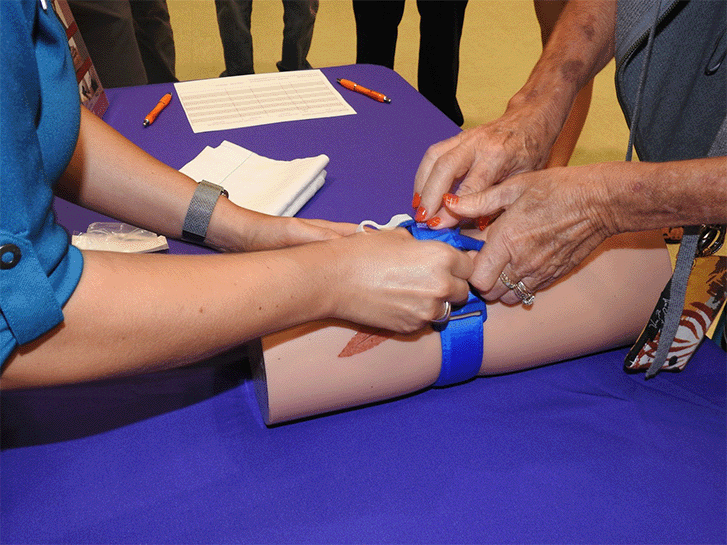 Instructor showing bleeding application to a student